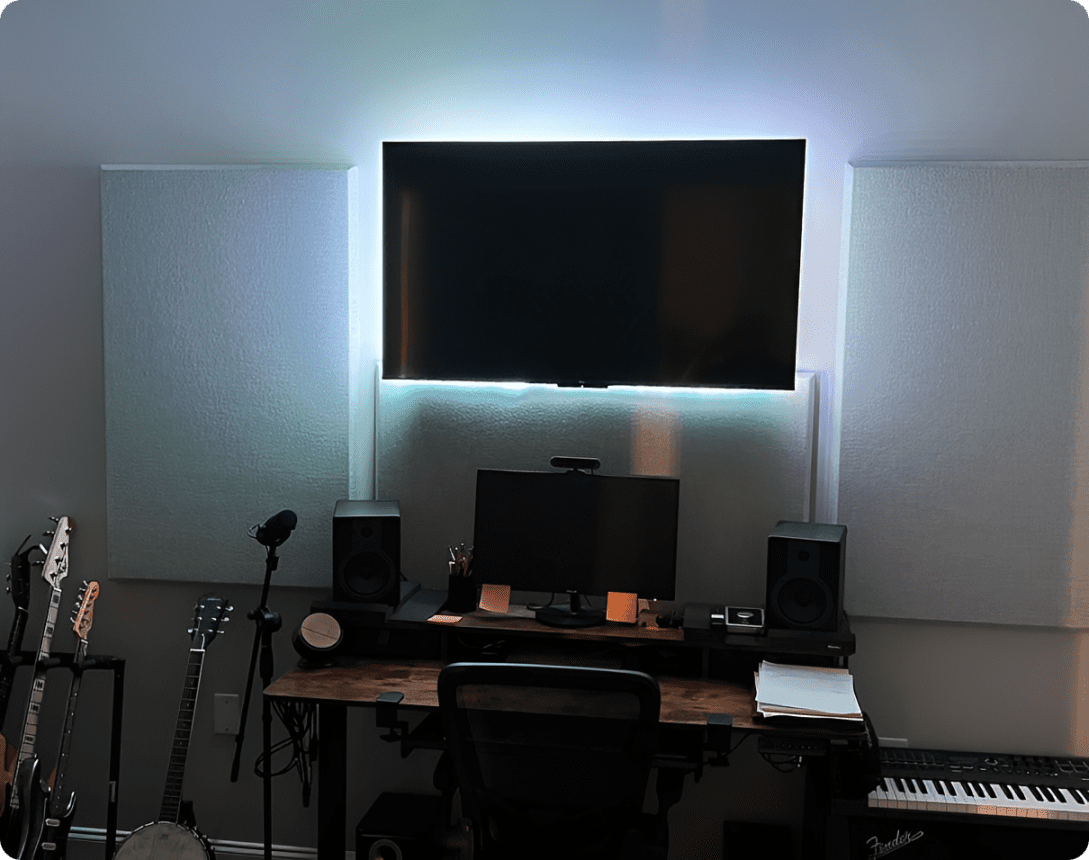 Home studio desk with monitors and instruments.