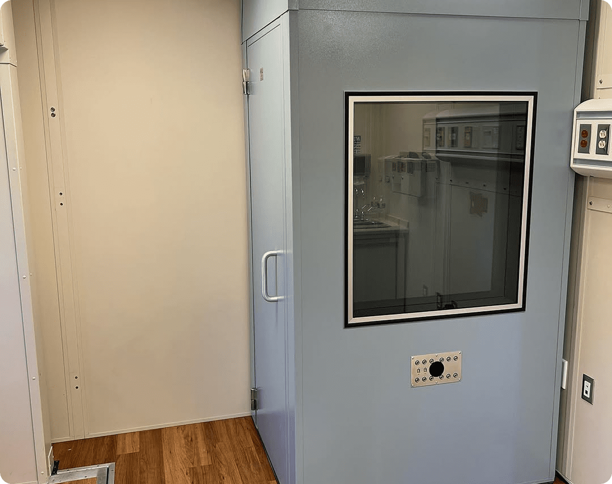 Room with a door and a window in it, as well as a wall with a glass window