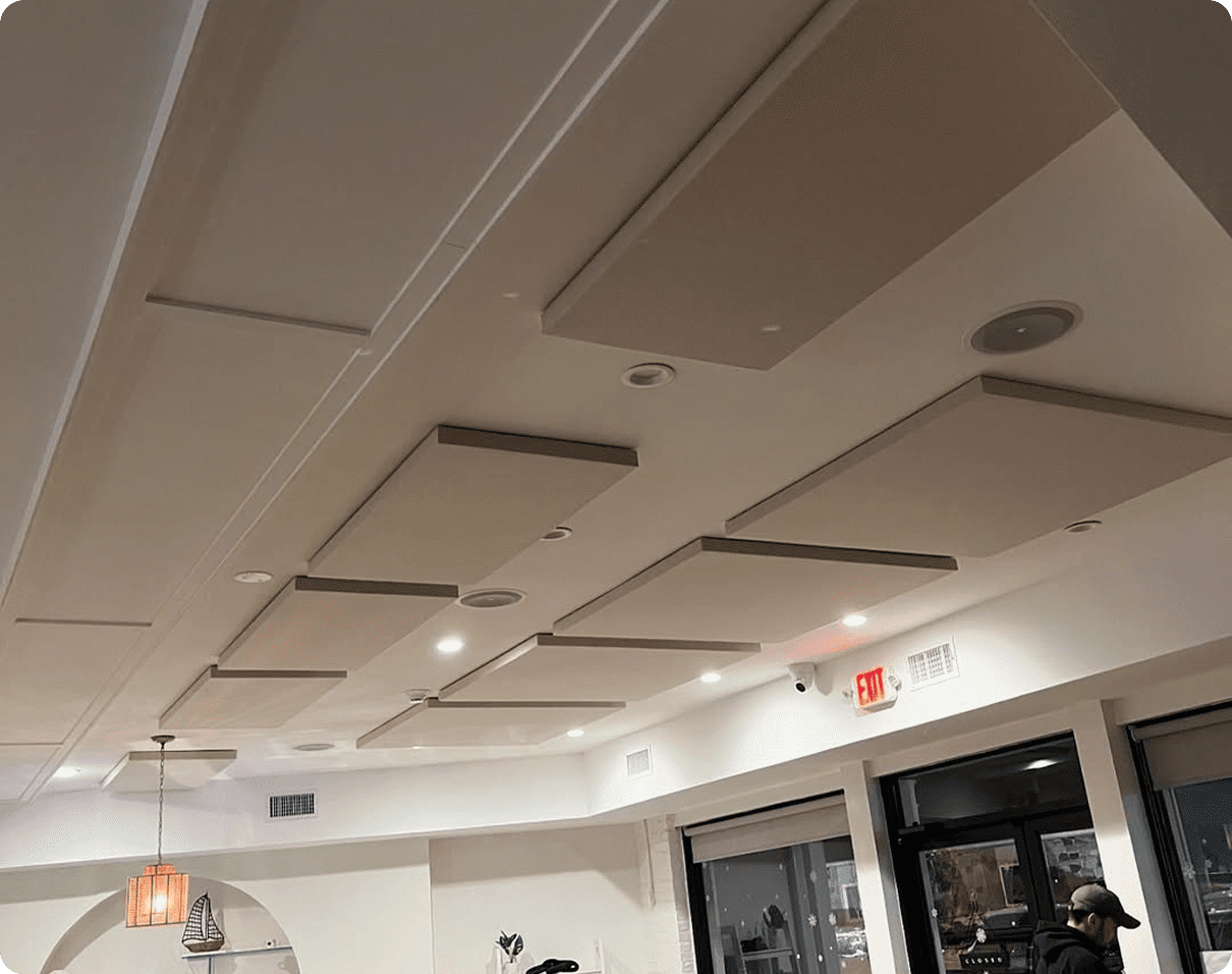 Man standing in front of a large room with a coffered ceiling featuring a decorative design