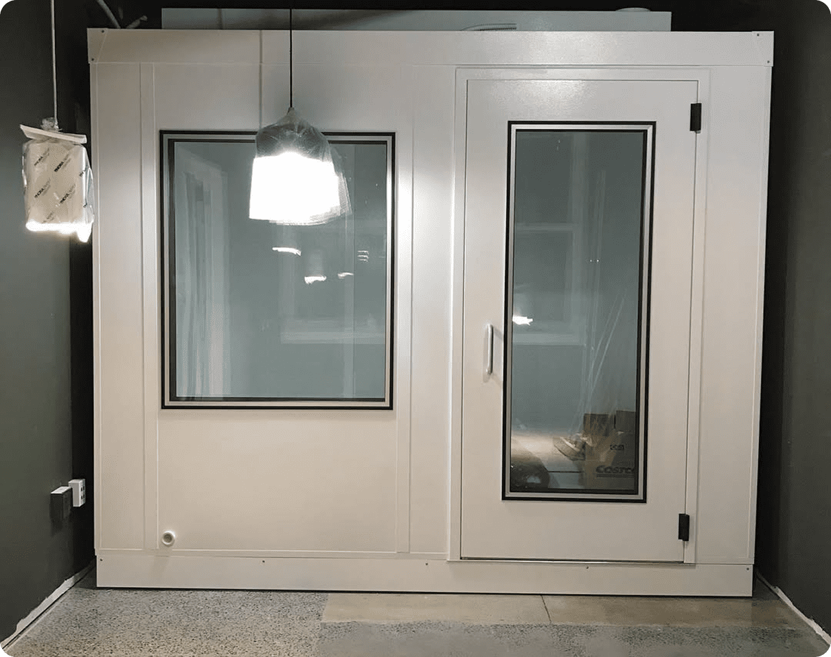 Room with a white door and a light hanging from the ceiling