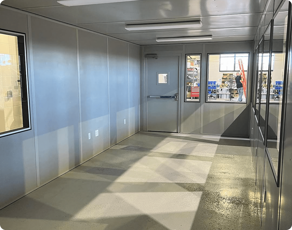 Large room with a lot of windows and doors, electric lights to the roof